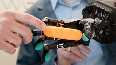 Robotic hand holding a plastic ring